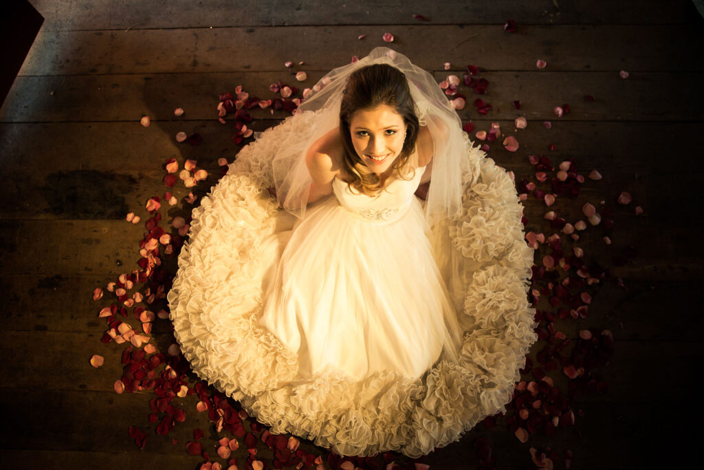 Bride-sitting-surrounded-by-pretty-freeze-dried-rose-petals.jpg