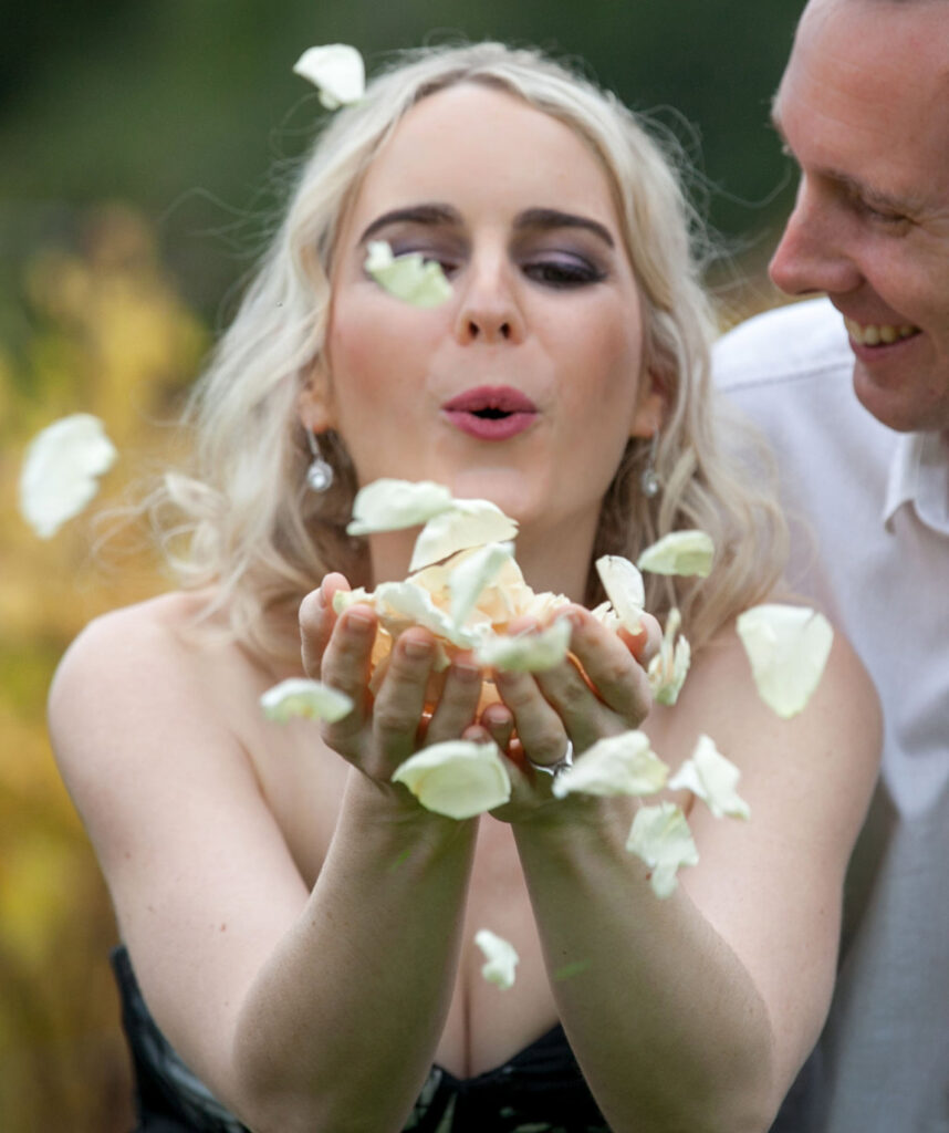 bride-with-champagne-rose-petals-in-hands.jpg