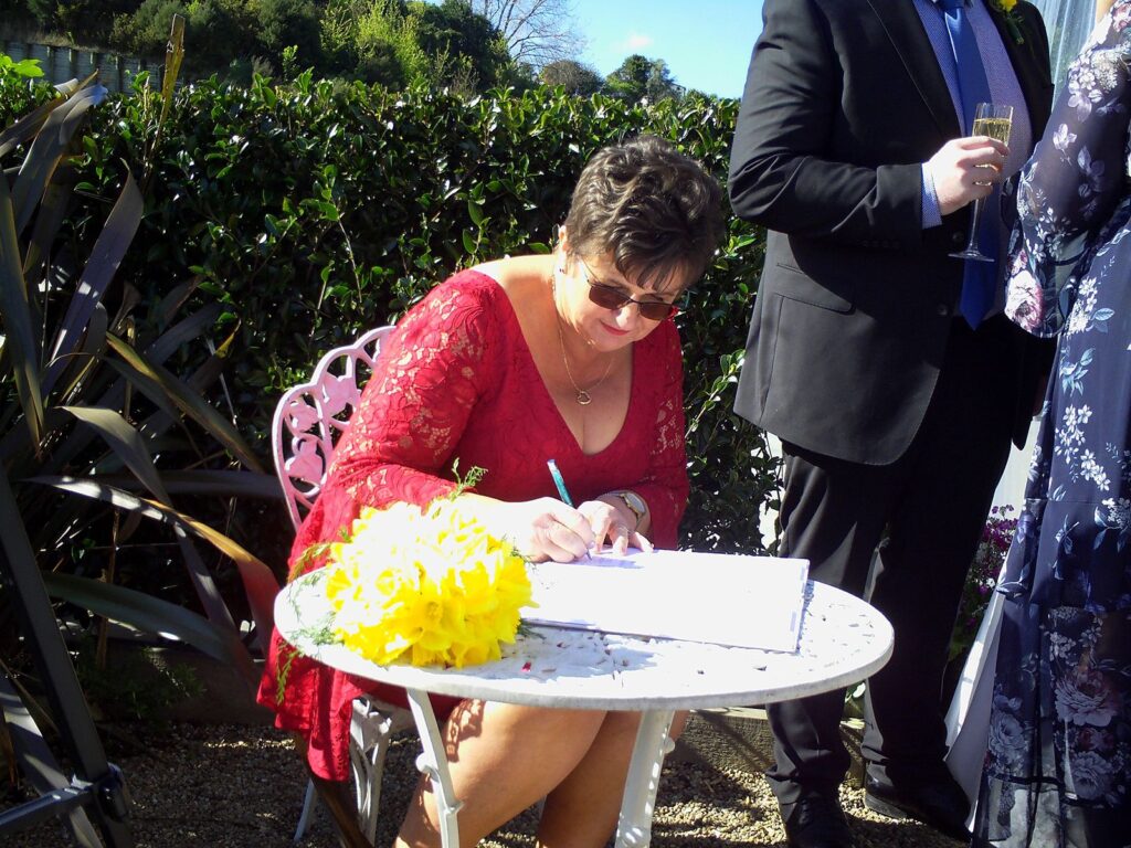 Tauranga-celebrant-Debbie-signing-license-Cloe.jpg